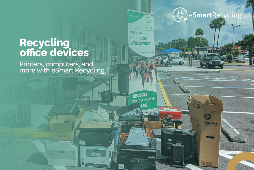 Office devices like printers and computers collected in a parking lot for recycling. eSmart Recycling banner and logo are visible. Text overlay reads: 'Recycling office devices. Printers, computers, and more with eSmart Recycling